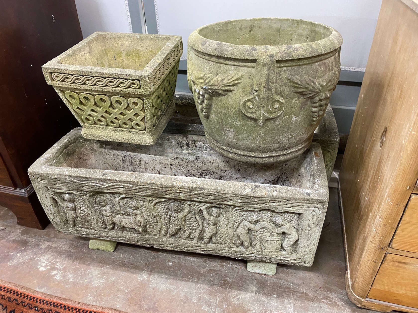 A pair of rectangular reconstituted stone garden planters length 80cm, a circular planter and smaller square planter.